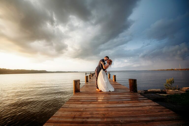 Herrington on the bay pier kiss with dramatic sky