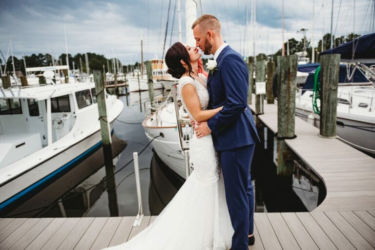 wedding bride and groom kiss by Herrington on the bay marina