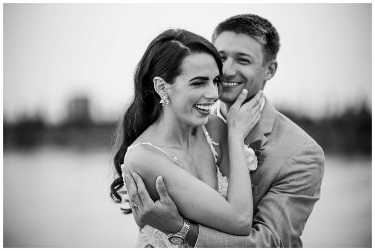 classic black and white photo of bride and groom. Bridal hair long down side part glamourous waves. Herrington on the Bay Annapolis waterfront wedding 
