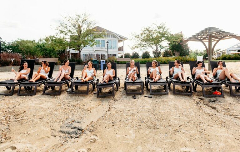 champagne toast on the beach with girls before wedding in Annapolis waterfront wedding at Herrington on the beach. Girls in prewedding pajama gifts